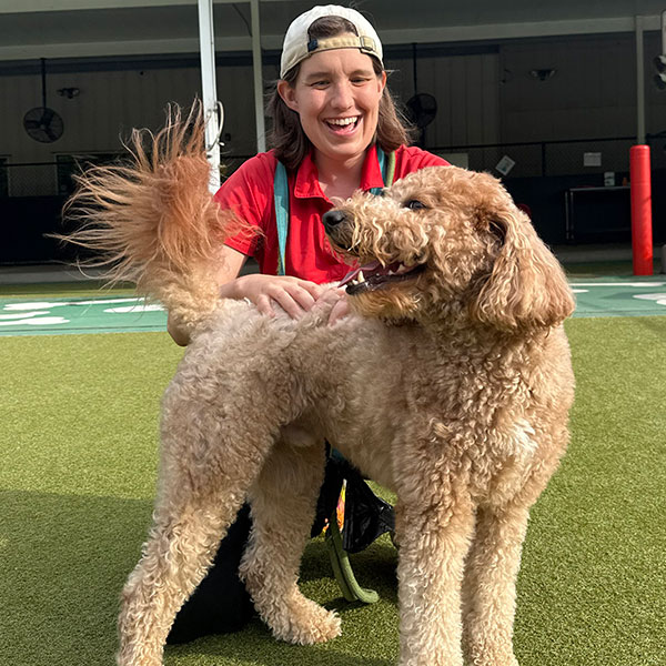 Staff petting a happy dog